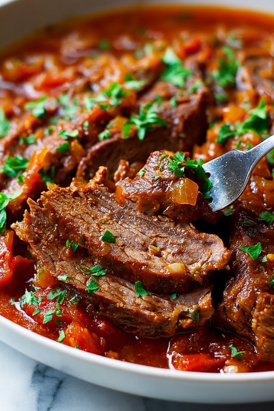 A close-up of several thick slices of cooked beef layered in a white bowl, covered with a rich brown-red sauce mixed with softened orange and yellow vegetables, garnished with small green parsley pieces scattered on top. A metal fork is pulling one slice, showing the tender inside of the beef. The background is a white marbled texture, enhancing the warm colors of the dish. photo taken with an iphone --ar 2:3 --v 7