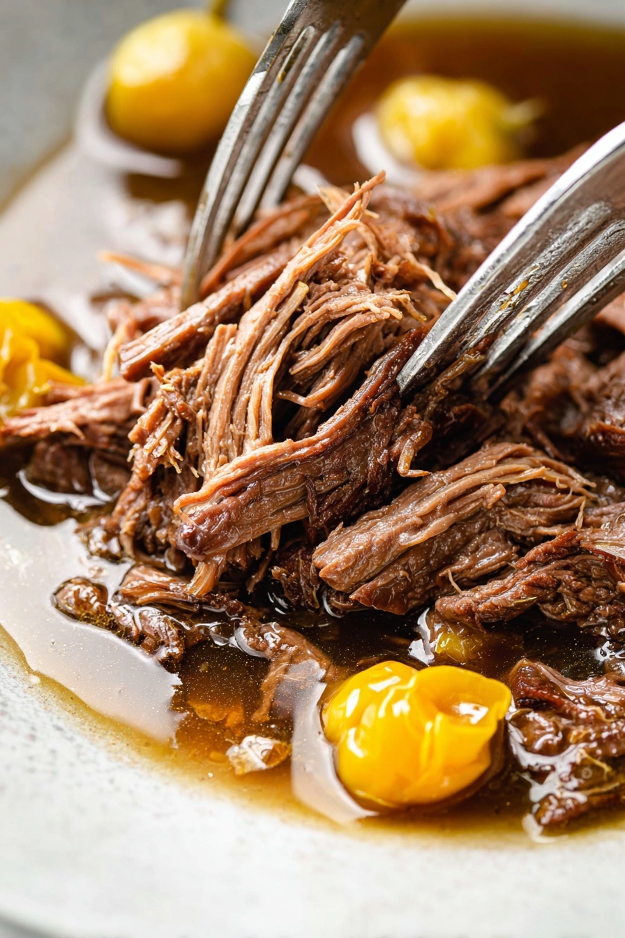 A white plate on a white marbled surface holds a base layer of creamy mashed potatoes with a soft, fluffy texture and a slightly uneven, swirled surface. On top, there is a generous pile of shredded dark brown slow-cooked beef mixed with small green herb pieces, adding freshness. Bright yellow pickled peppers rest on top and around the beef, adding color contrast. A knife with a wooden handle is placed on the plate's edge, partially touching the mashed potatoes. Small scattered herb bits and black pepper are sprinkled over the dish, giving a fresh and seasoned look. In the background, there are more white plates with similar dishes and a small bowl of yellow peppers. Photo taken with an iphone --ar 2:3 --v 7
